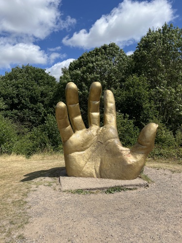 golden hand statue in the country park
