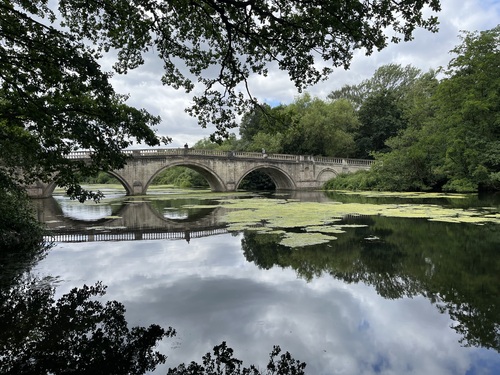 the bridge reflected perfectly in the mirror like surface of the lake