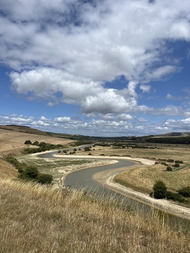The River Cuckmere meandering through the valley, seen from the hillside above Exceat