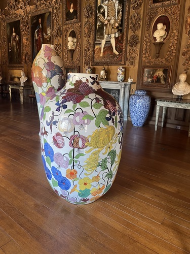 A tall floral porcelain vase in the Carved Room, with Grinling Gibbons' wood carvings behind