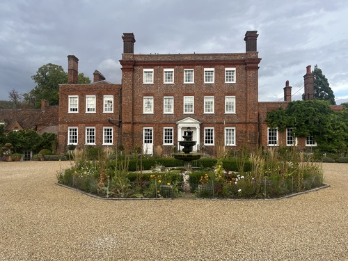 Champneys Henlow Grange, a red brick Georgian house with a gravel drive and fountain garden
