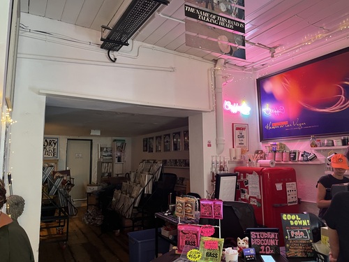 Inside Bella Union record shop, red Smeg fridge, neon coffee sign, and racks of vinyl records