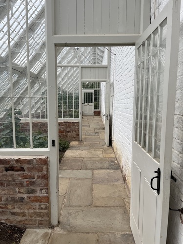 A run of doorways through the Quarry Bank greenhouses