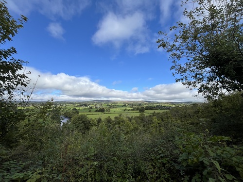 View over the river towards green hills