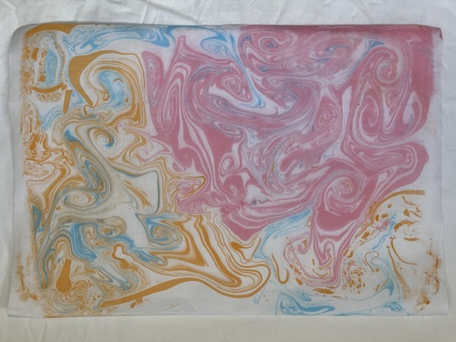 Attempt 3 of Suminagashi using blue, orange and pink inks
