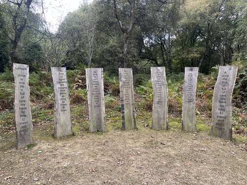Seven wooden boards carrying the poem Leisure by W H Davies