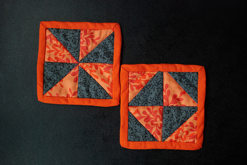 Two orange & grey coasters